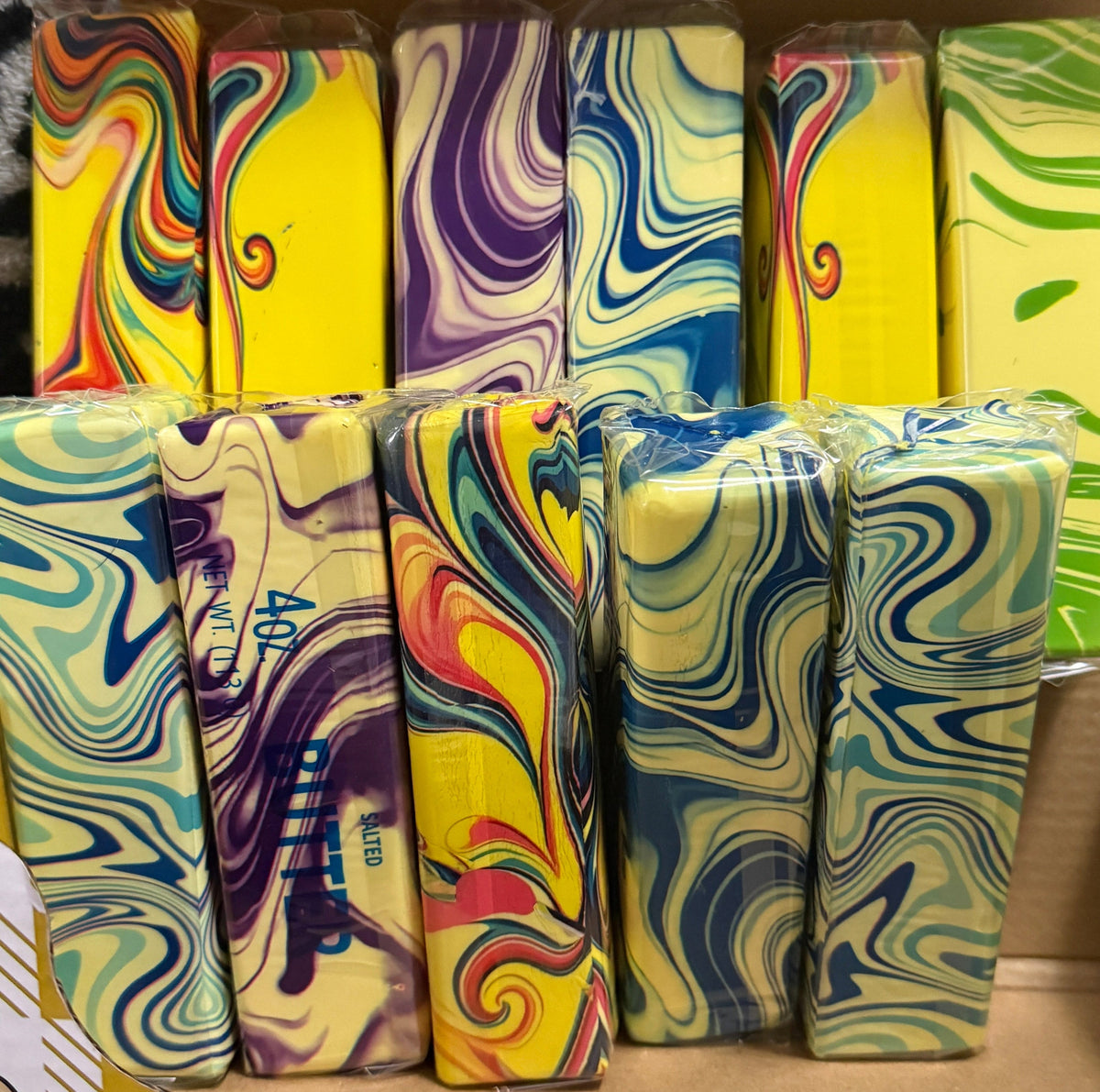 Individually wrapped butter-shaped squishies with multicolored marbled patterns