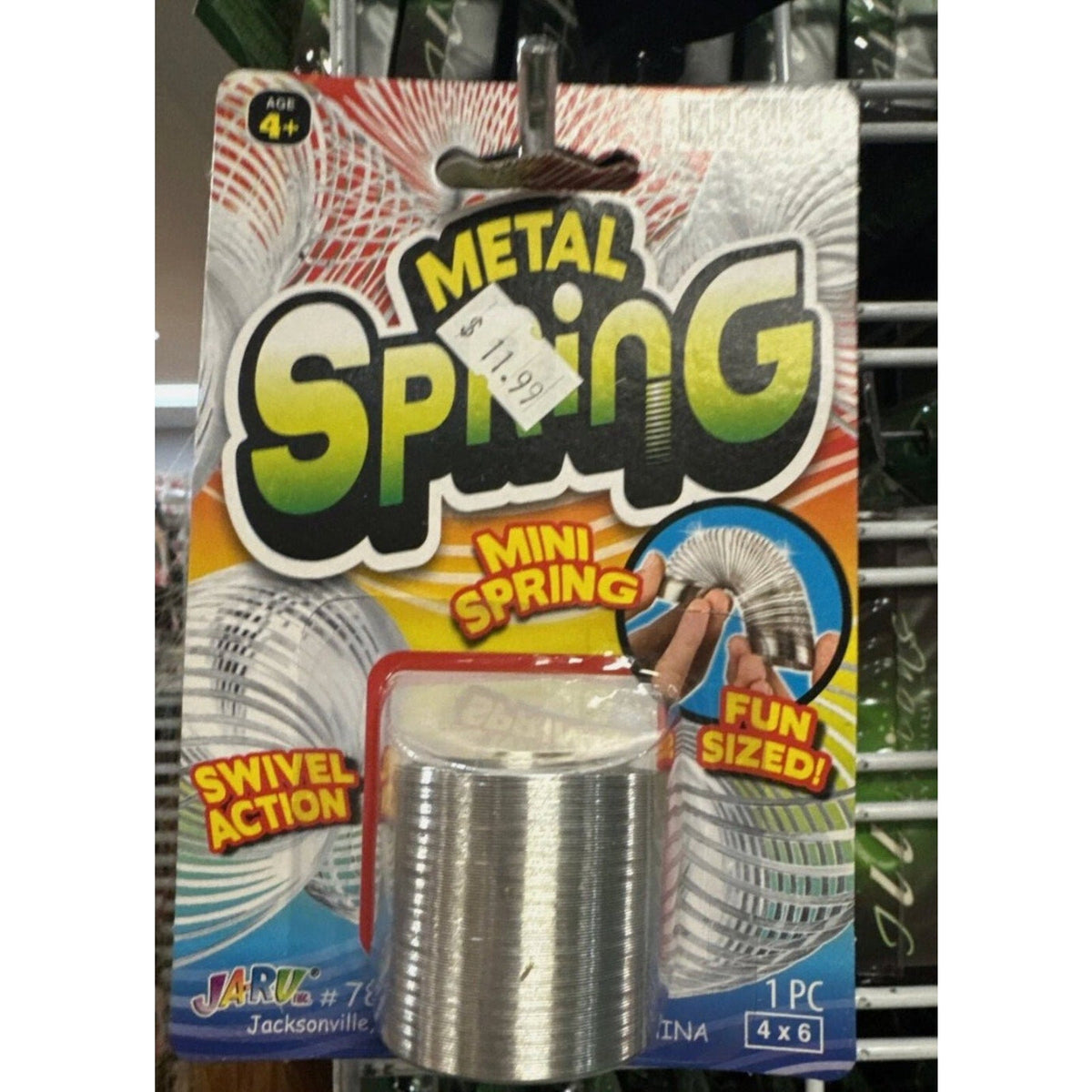 Coiled silver-colored metal spring in JA-RU Mini Spring blister packaging