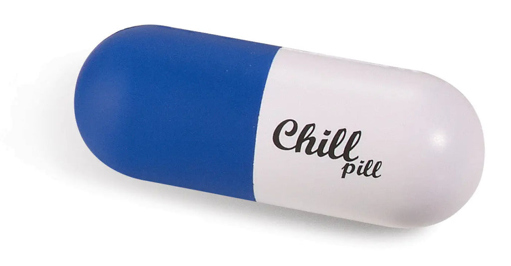 Blue and white capsule-shaped squeeze toy printed with the words Chill pill