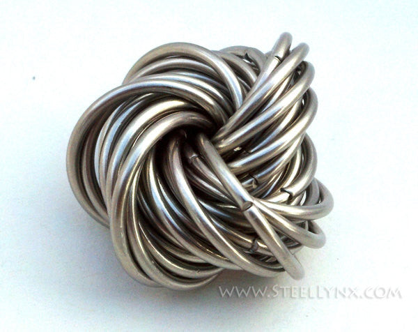 Ball made from interwoven silver-colored metal rings