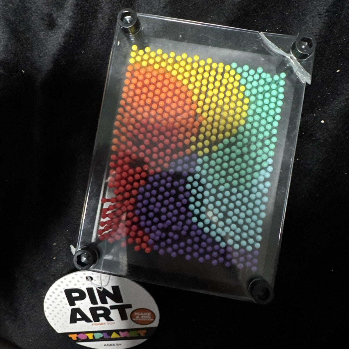 Rainbow pin-art design in a black rectangular frame, with Pin Art packaging
